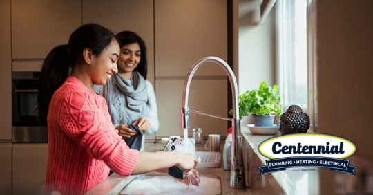 family washing dishes in kitchen
